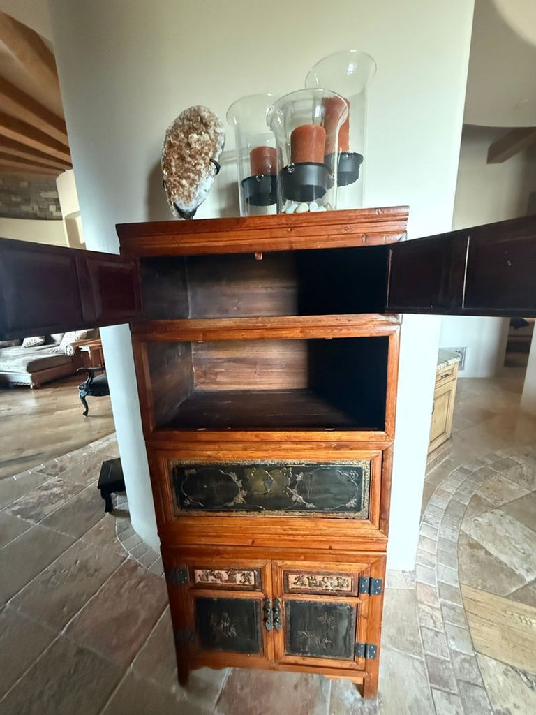 2. Open wooden dresser showing spacious shelves, black decorative panels, and glass candle holders on top.