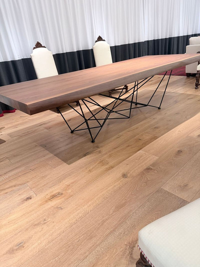 1. Cattelan Italia dining table with a solid wood top, natural edge, and geometric black metal base.