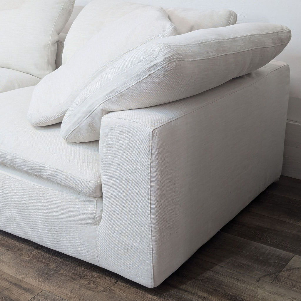 Close-up of the L-Shaped sectional sofa's plush cushions and side arm.