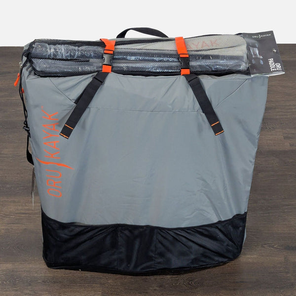 Oru Kayak Inlet backpack with padded straps and mesh pocket, designed for carrying kayaks and gear outdoors.