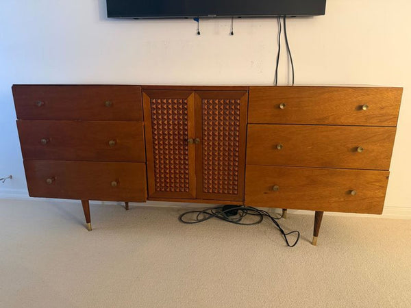 Mid-century modern entertainment center with wood finish, six drawers, and center cabinet for organized storage.