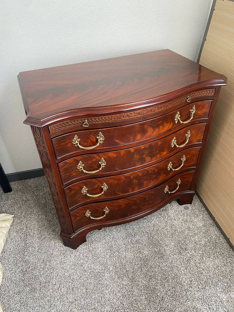 Classic Henkel-Harris mahogany dresser featuring a graceful curved front, ornate brass pulls, and sturdy construction.