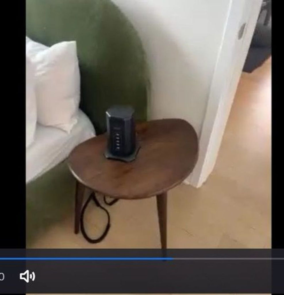 2. 2x side table in good condition, dark wood finish, shown next to a bed with a small device on it.