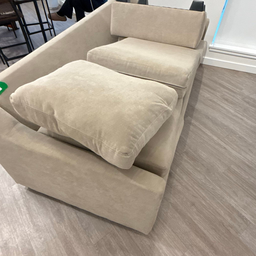 2. Top view of a beige 3-seat Couch brand sofa with removable cushions, shown on a wooden floor.