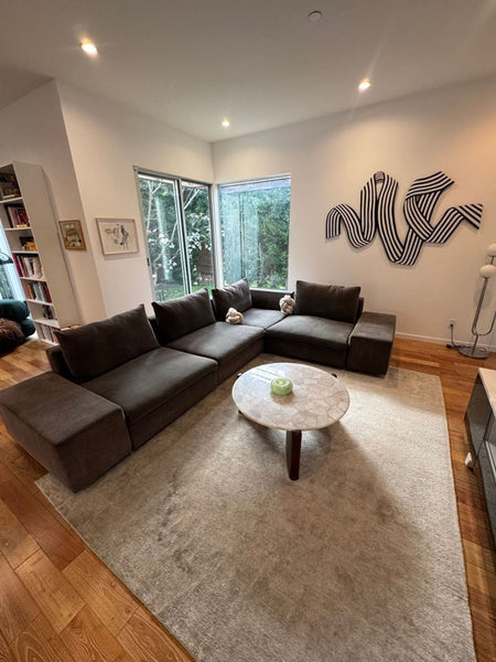 1. Modern gray Eilersen sectional sofa with L-shape and plush cushions, ideal for spacious living areas.