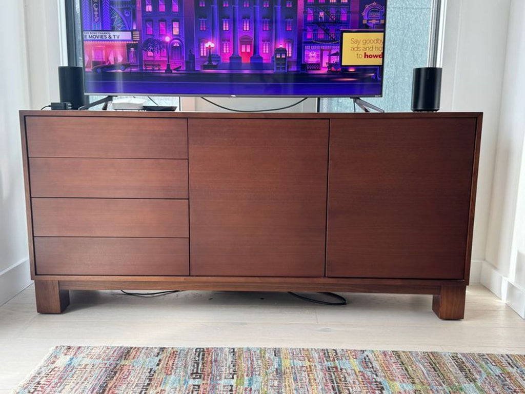 1. Modern walnut sideboard from Mitchell Gold + Bob Williams, featuring drawers and doors, shown in a living room.