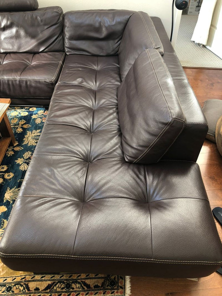 Contemporary Cierre Imbottiti sectional, brown leather upholstery, wide arms, and tufted seat cushions.