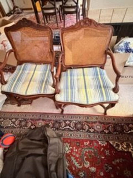 1. Pair of vintage wooden dining chairs with cane backs and striped blue and yellow seat cushions.  