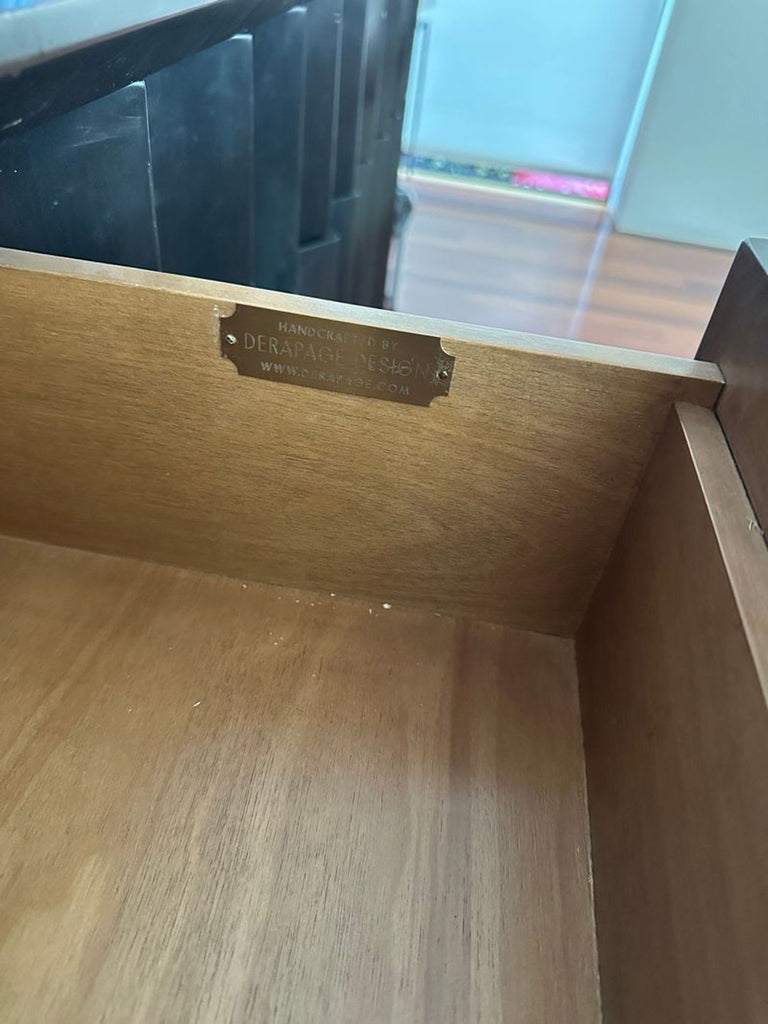 2. Close-up of interior drawer label reading "Handcrafted by Derepage Design" inside wooden sideboard.  