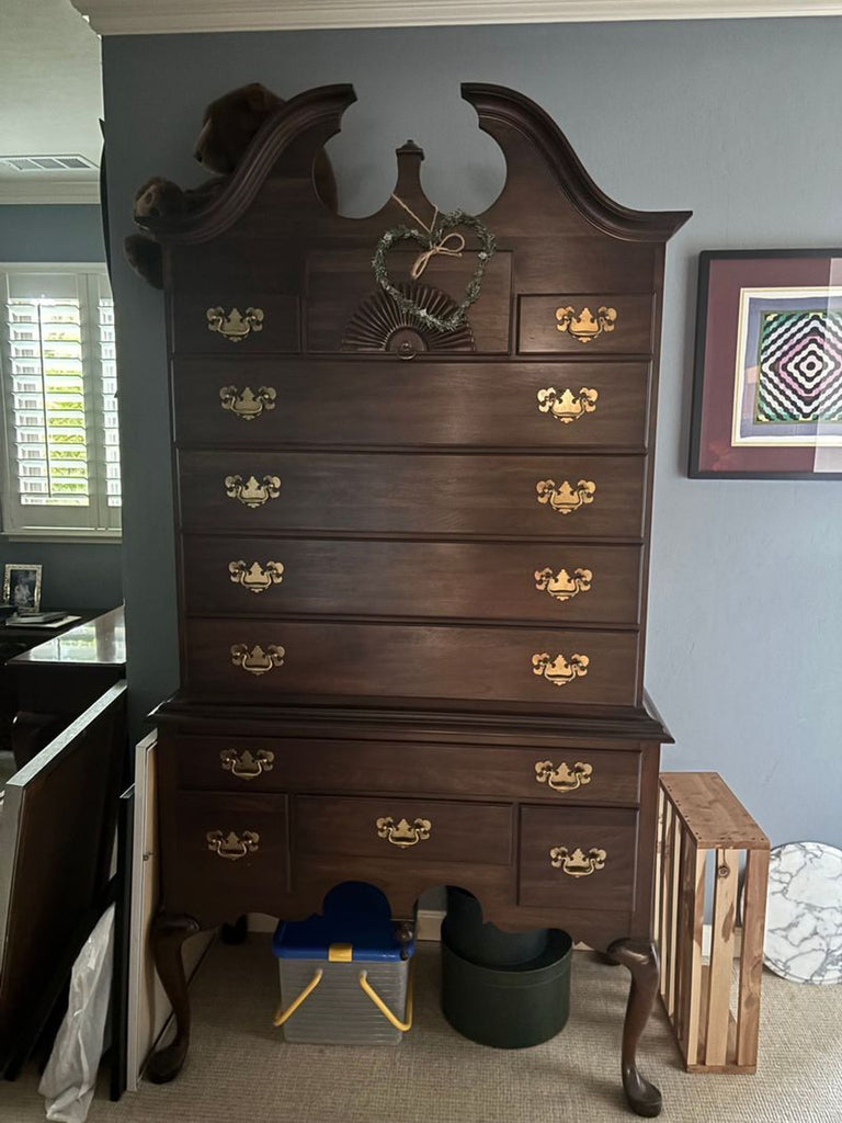 1. Tall, dark wood Pennsylvania House dresser with brass handles and decorative top, against a blue wall.  