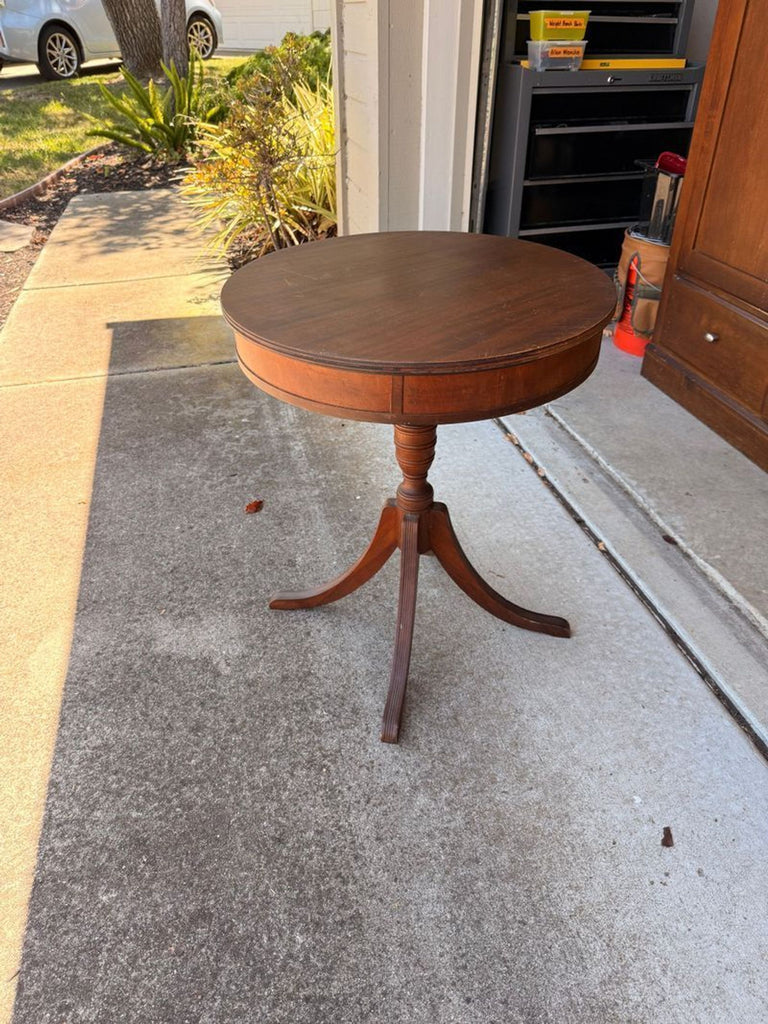 1. Modern wooden end table with a square tabletop and slim, tapered legs in a living room setting.