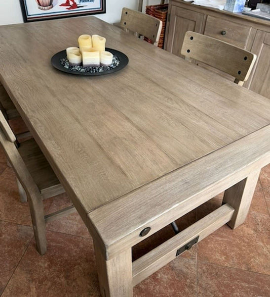 Pottery Barn Benchwright Seadrift dining table and six chairs arranged as a matching dining set.