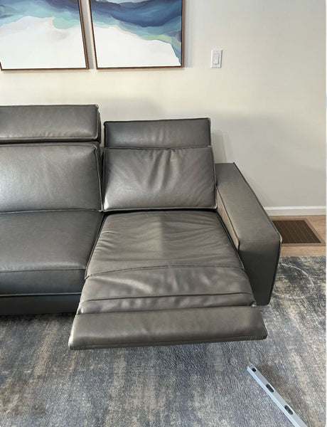 1. Close-up of West Elm Axel leather sectional with an extended reclining seat on a textured rug.