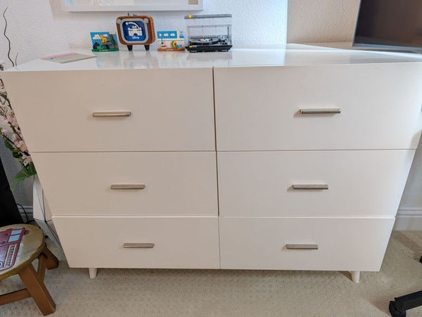 1. White Westelm dresser with six drawers, silver handles, and decorative items displayed on top.