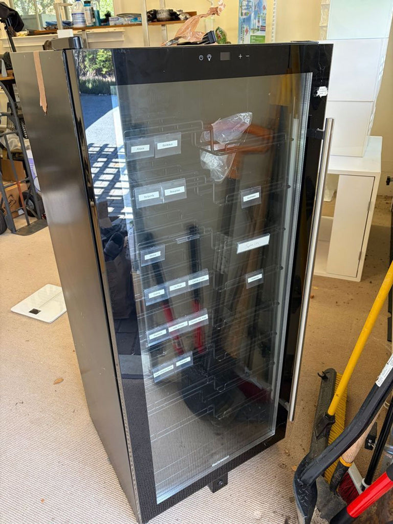 Sleek Wine Enthusiast wine cellar with glass door, Wi-Fi enabled, fits under-counter, stores multiple wine bottles.