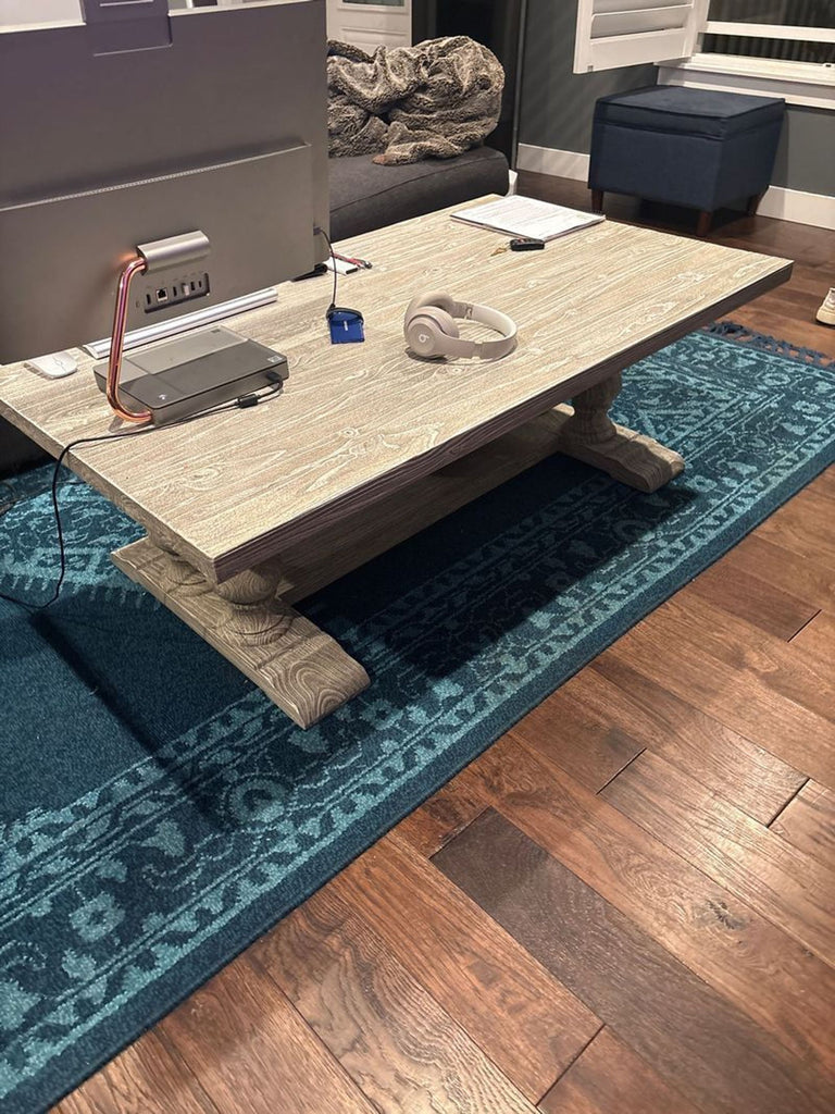 1. Reperch coffee table with a rustic wood finish, shown in a living room setup with electronics on top.