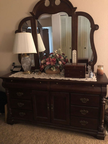 a dresser with a mirror and a dresser 