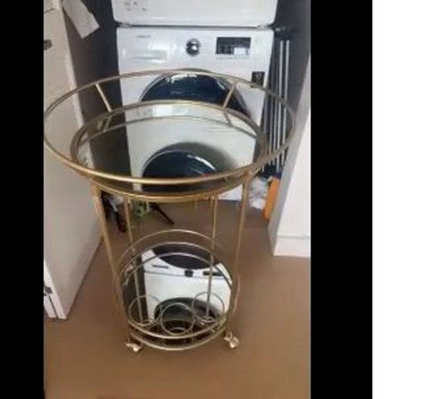 1. Gold-framed 2x bar cart with mirrored shelves and wheels, shown in a laundry room setting.  