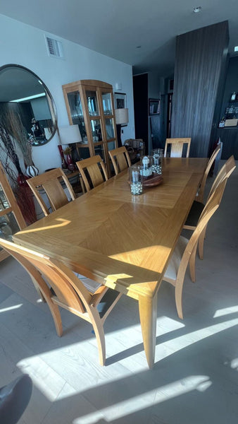Light wood Ethan Allen dining set with rectangular table and matching chairs, shown in a modern home interior.  