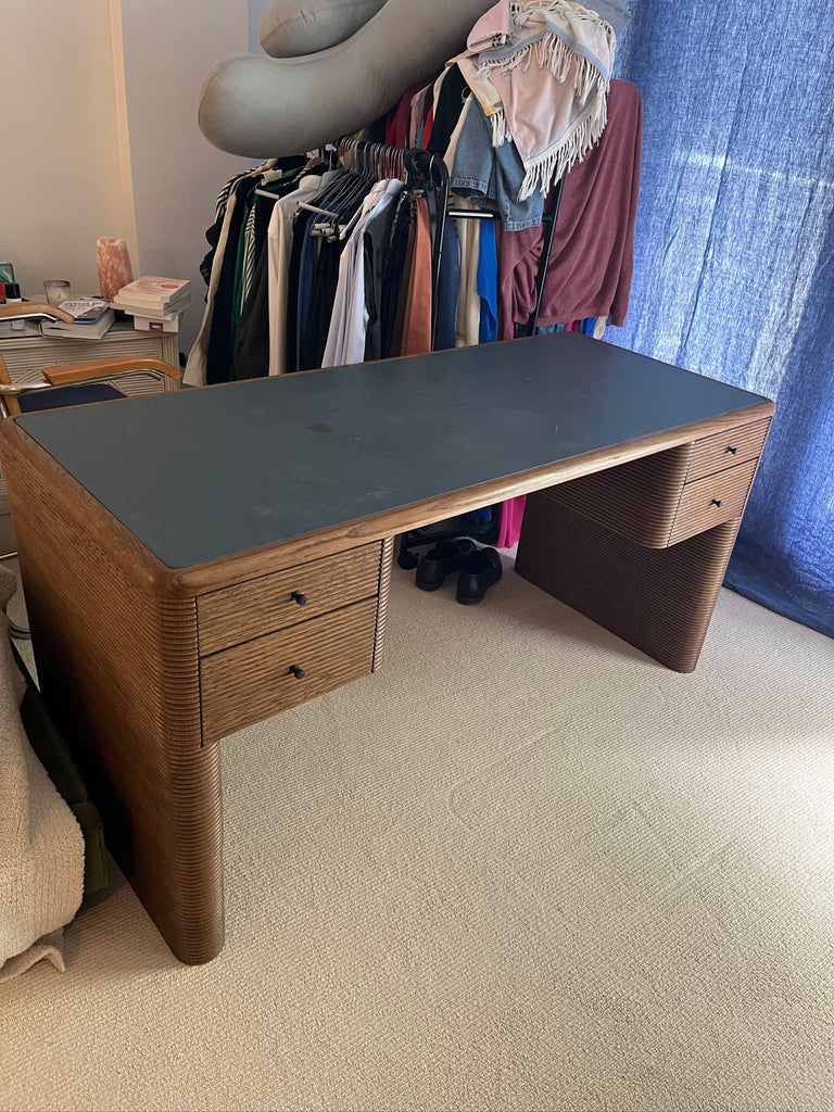 Contemporary desk from SOHO Home with a smooth black top, wood construction, and side drawers for organization.