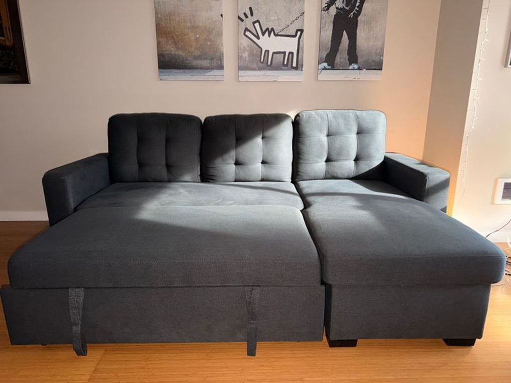2. Ana Furniture sectional sofa extended into a bed, showing its convertible sleeper feature in a sunlit room.