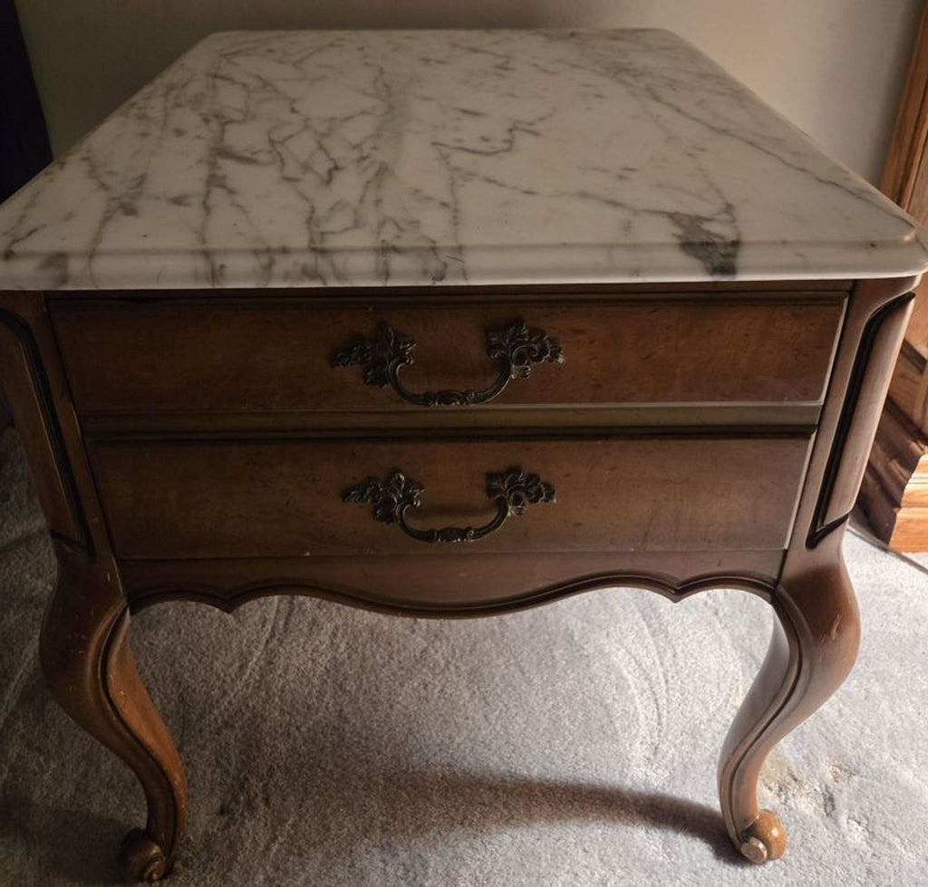 1. Reperch end table with a white marble top, wooden body, two drawers, curved legs, and ornate handles.