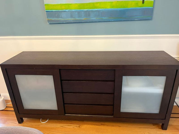 Crate and Barrel sideboard with sliding doors, showing inner shelves; perfect for storage and display.  