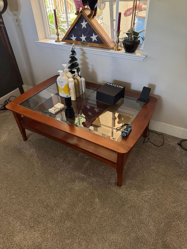 Certainly! However, I didn't receive any images or specific details about their content except the category (Coffee Table) and brand (Glass top coffee table). Based on this limited information, here are three distinct and summarized alt text suggestions with a 100-character maximum: