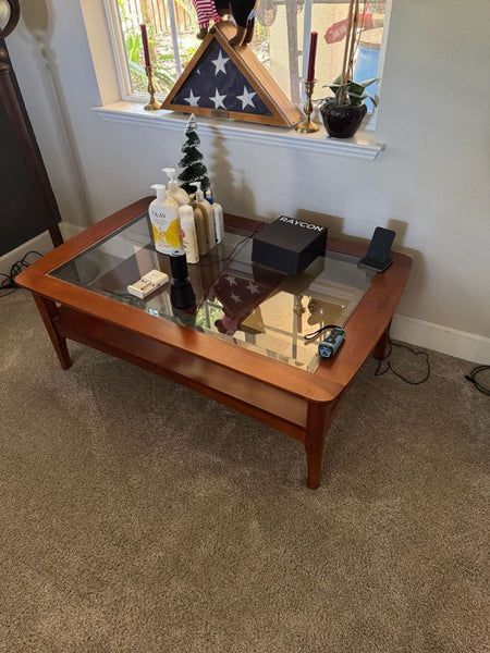 Certainly! However, I didn't receive any images or specific details about their content except the category (Coffee Table) and brand (Glass top coffee table). Based on this limited information, here are three distinct and summarized alt text suggestions with a 100-character maximum: