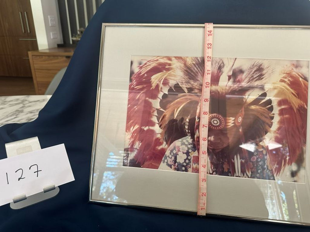 3. Framed print of a person in ceremonial attire, with a measuring tape vertically showing the item's height.