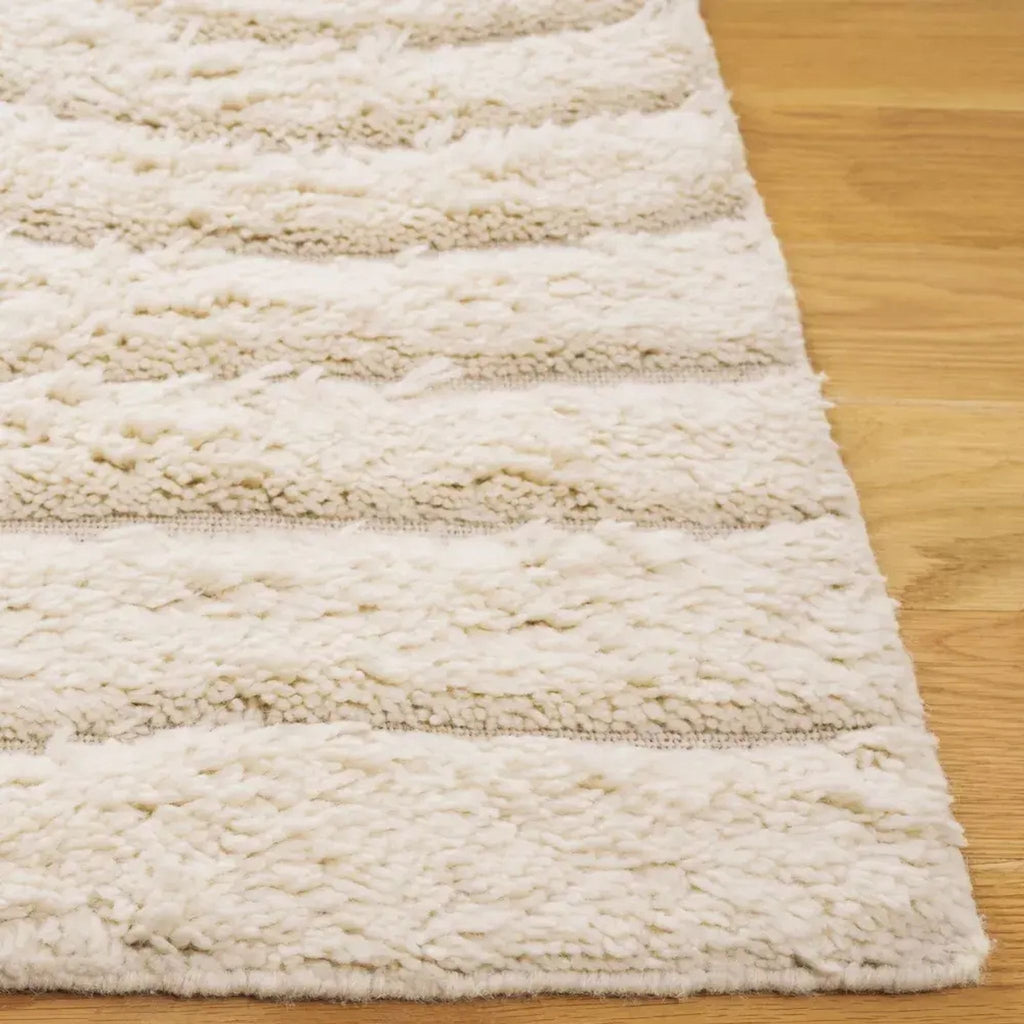 3. Close-up of Reperch brand cream rug, highlighting plush, thick, raised wavy texture on wooden floor.