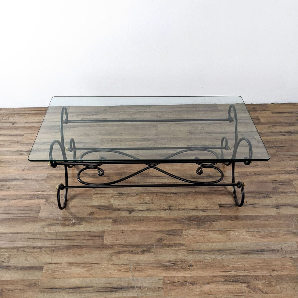 Elegant coffee table by Reperch, with a scroll metal base and clear glass surface.