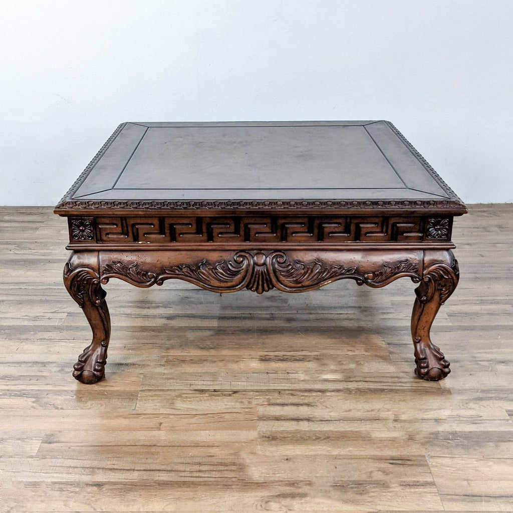Side view of the Reperch coffee table with ornate carvings.