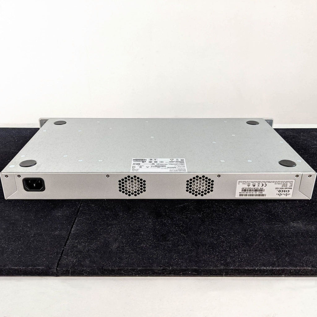 Rear view of Cisco & Bros. networking equipment, showing ventilation grilles, power socket, and label details.  