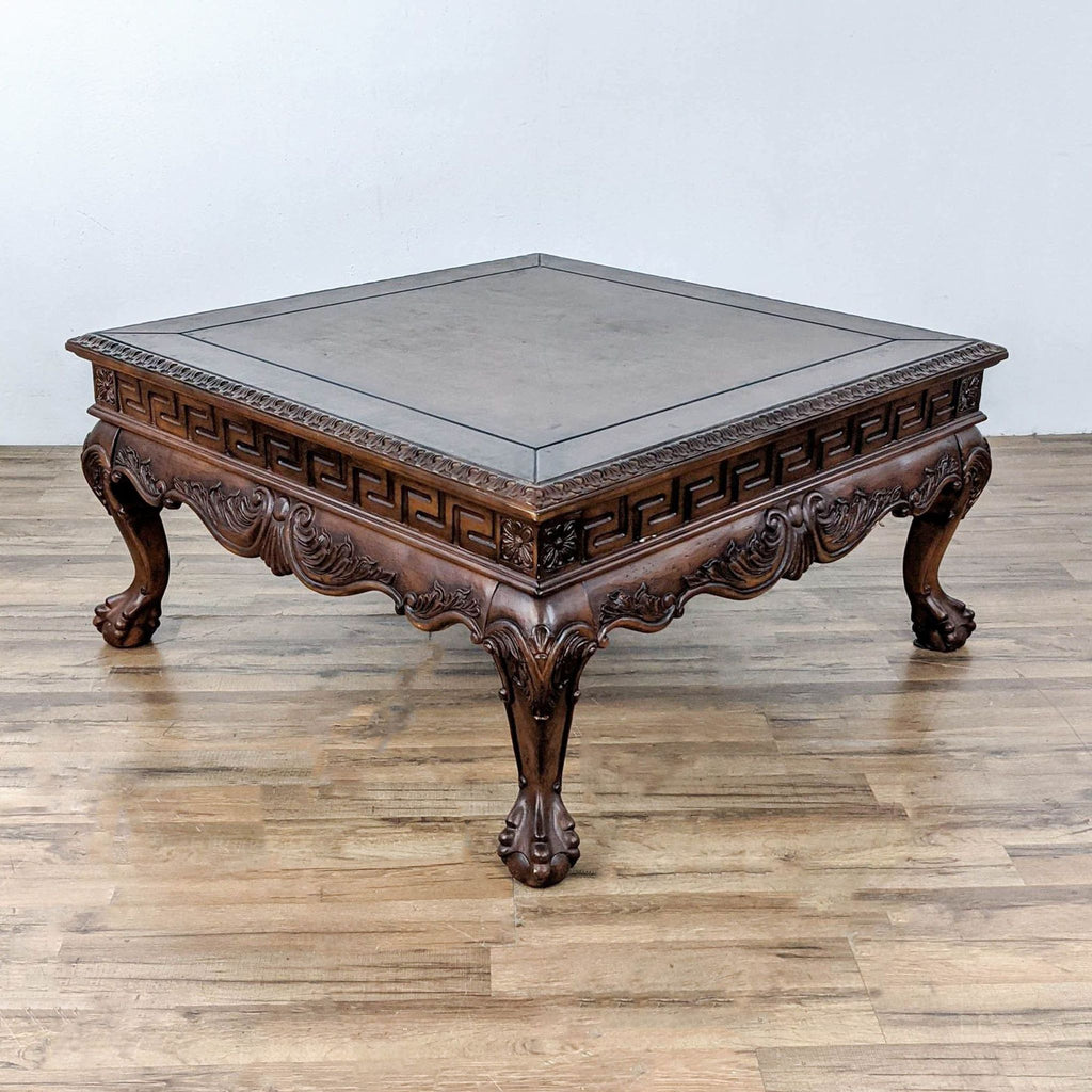 Carved coffee table with leather top, Greek Key apron, cabriole legs.