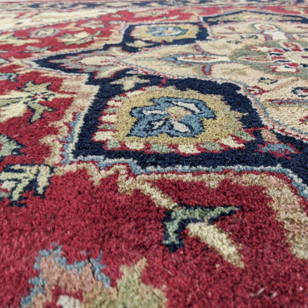 3. Macro image showing thick wool texture and colorful pattern on a red Safavieh Heriz Oriental rug.
