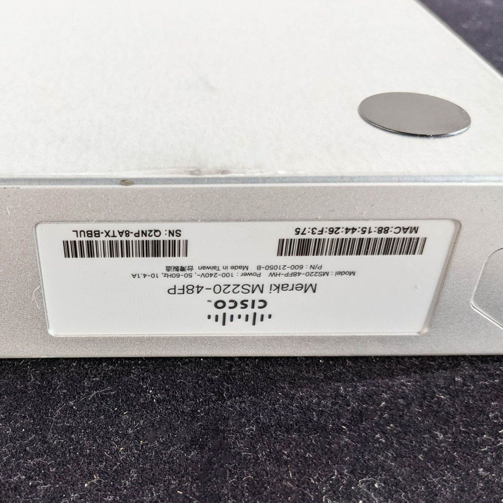 2. Close-up of Cisco & Bros. Meraki MS220-48FP label with serial and MAC address on silver networking equipment.