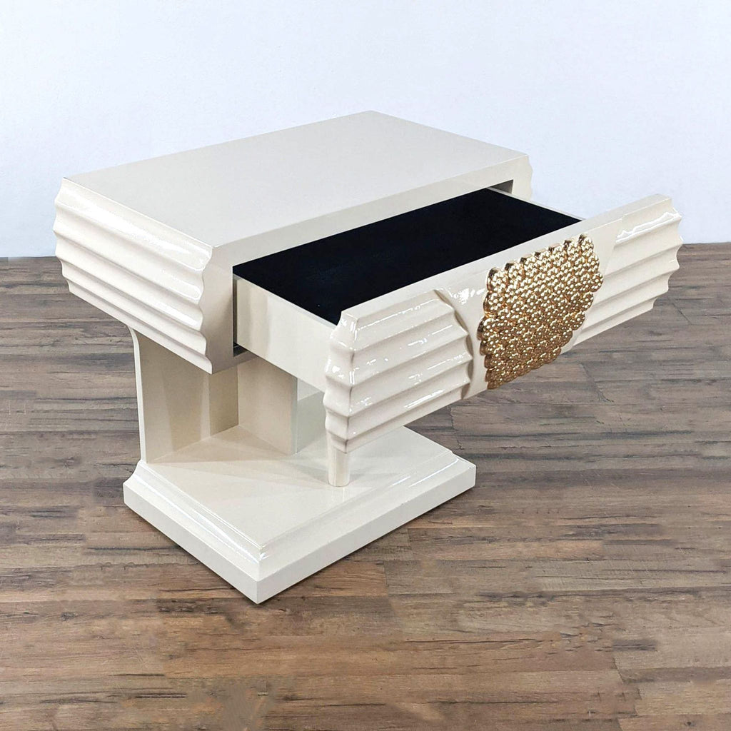 Two cream end tables with intricate gold metal accents.