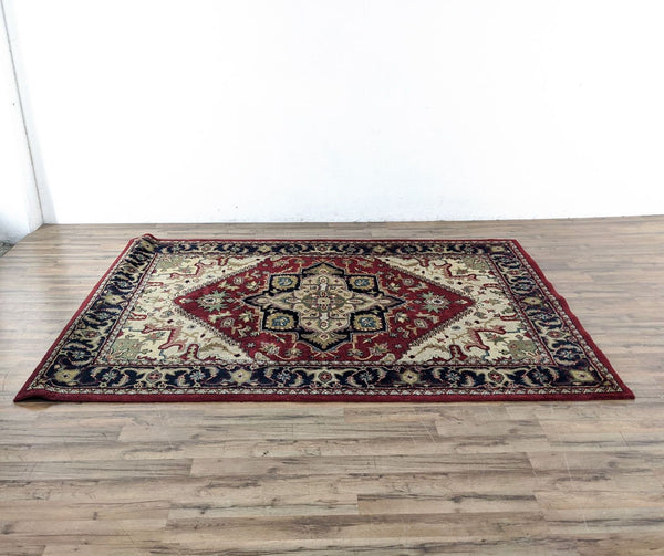1. Safavieh Heriz style rug, 100% wool, red with intricate medallion pattern, approximately 6' x 9', made in India.