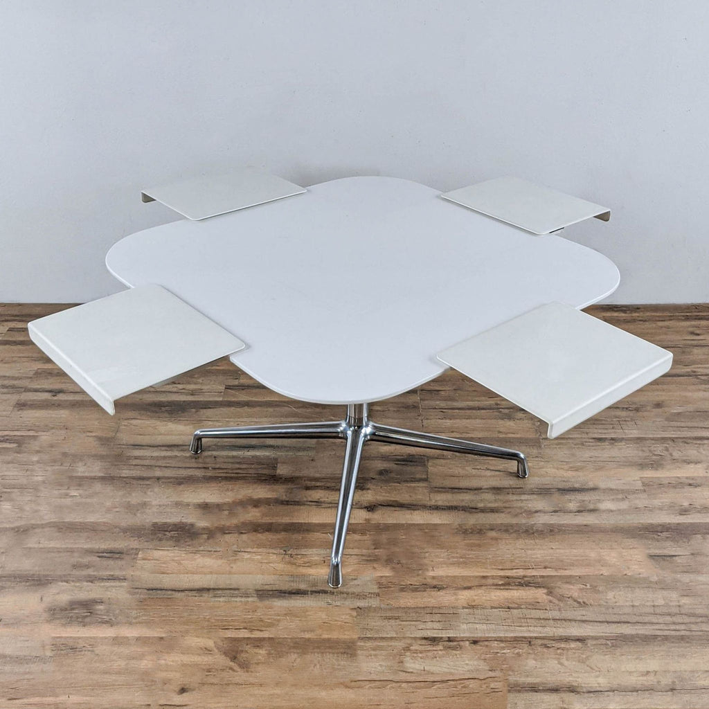 Unusual white square table with rounded corners and chrome frame.