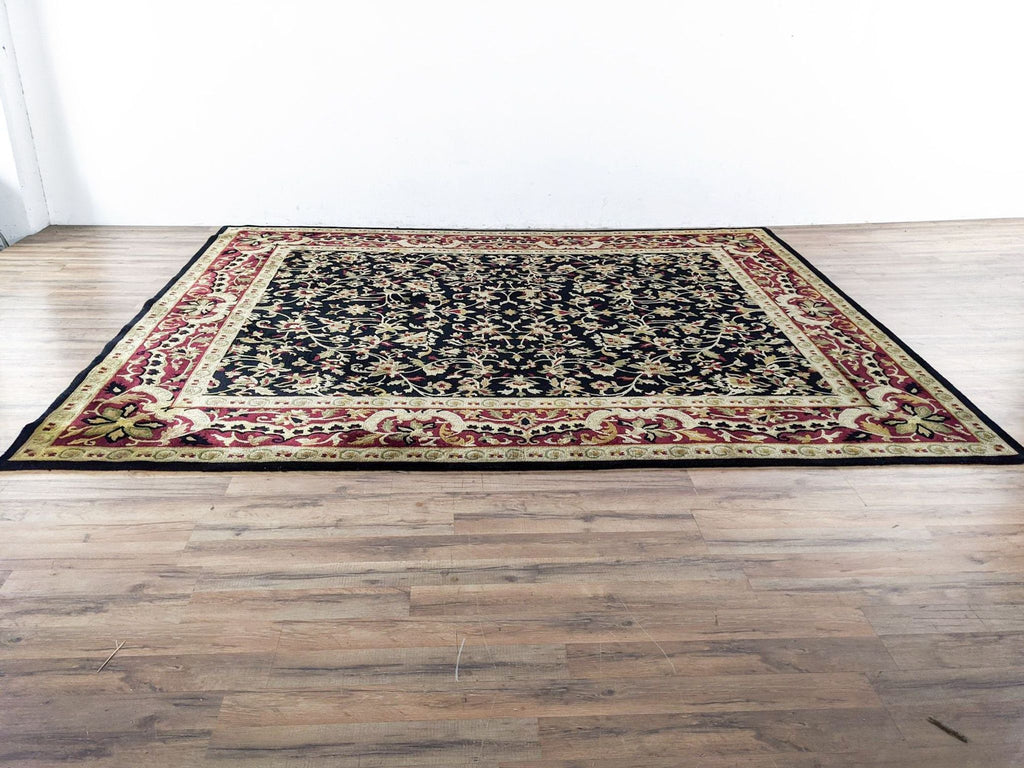 a large oriental rug with a black and red pattern.