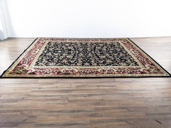 a large oriental rug with a black and red pattern.