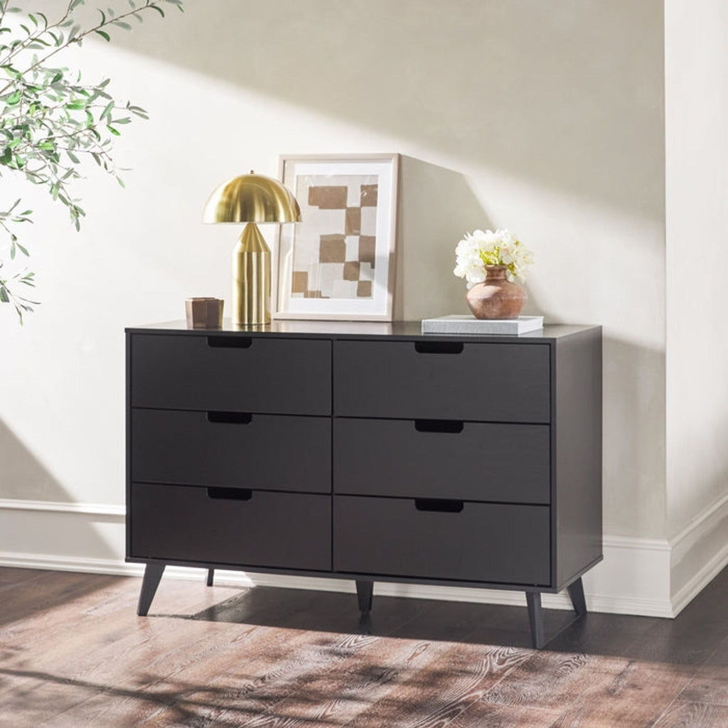 a sideboard with drawers and a lamp on the side.