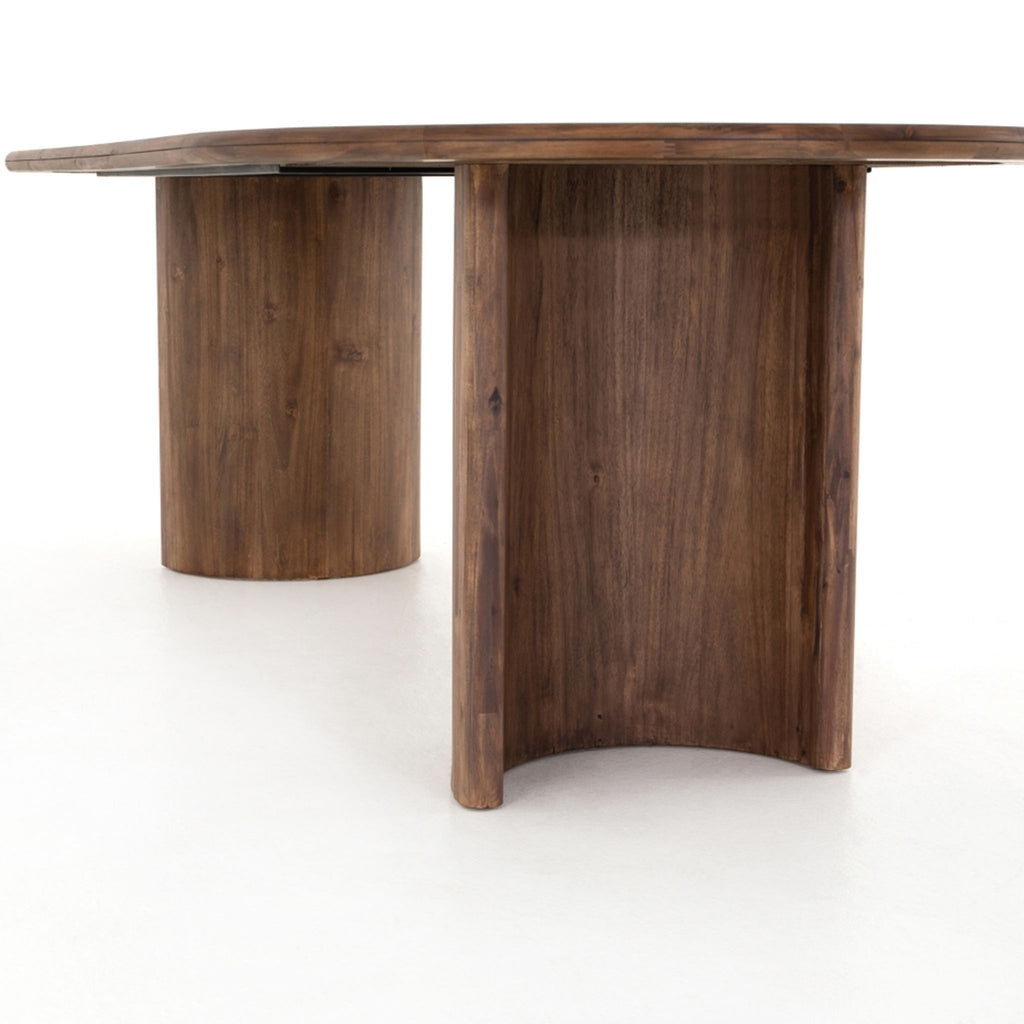 a large, rectangular, walnut table with a curved top.