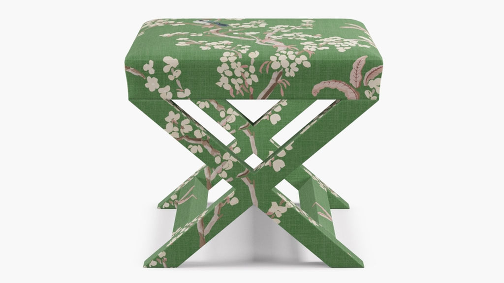 a green and white stool with a floral pattern