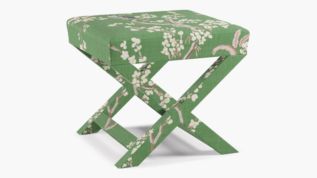 a green and white stool with a floral pattern
