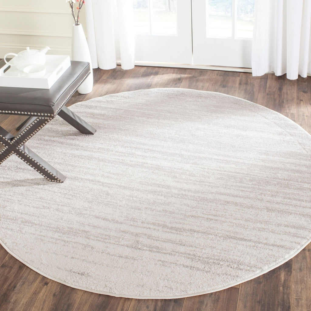 a living room with a wooden floor and a rug 