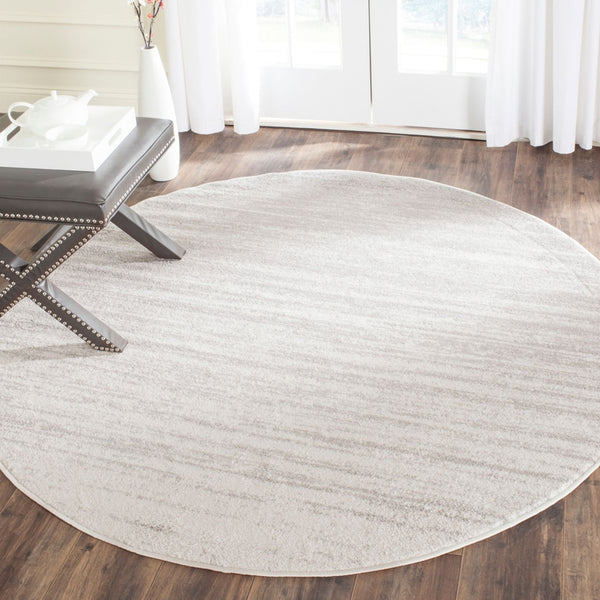 a living room with a wooden floor and a rug 