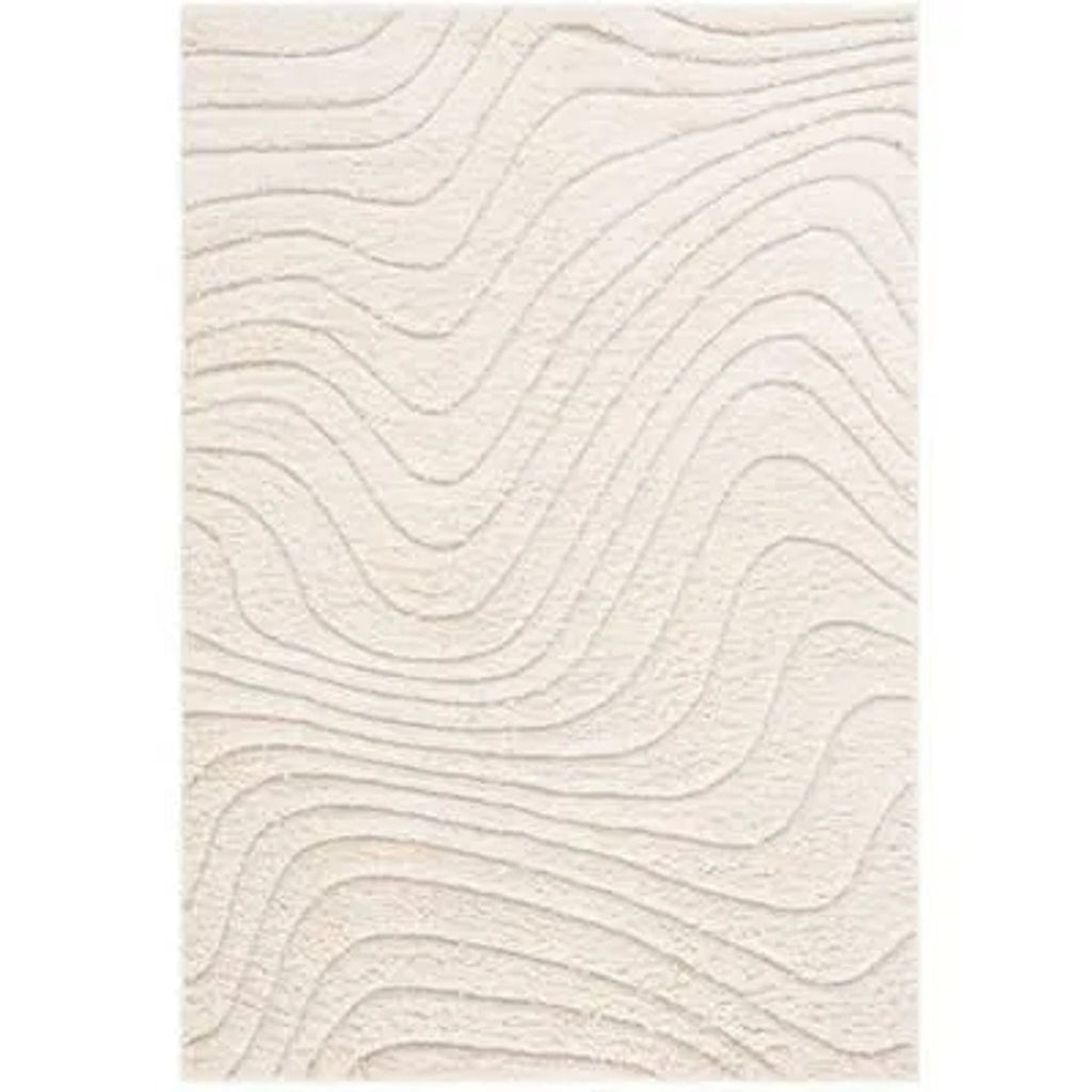 1. Cream Reperch rug with raised wavy line texture, viewed from above against a plain background.