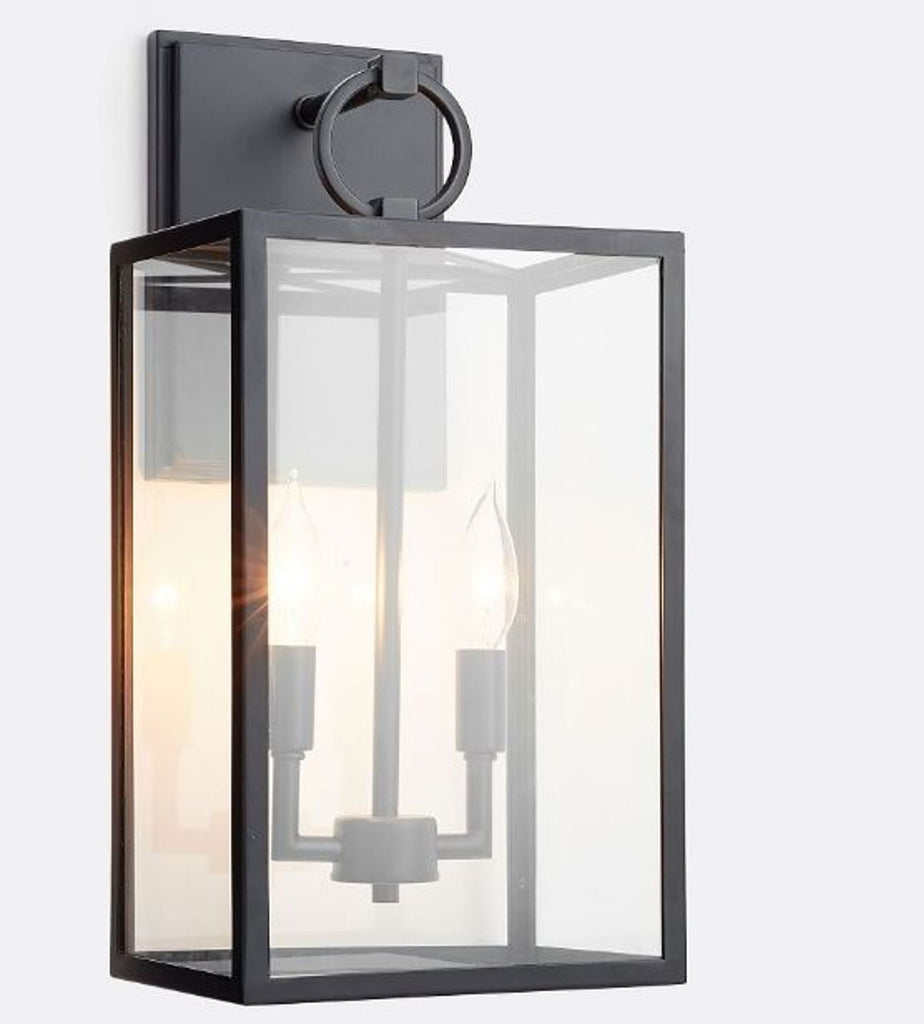 1. Bronze-finished wall sconce with clear glass panes from Pottery Barn, showcasing two visible candle-style lights inside.